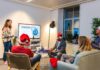 Festive Burnout Takes Toll on Wellbeing as Workers Struggle to Switch Off Office staff sit while wearing Santa hats.