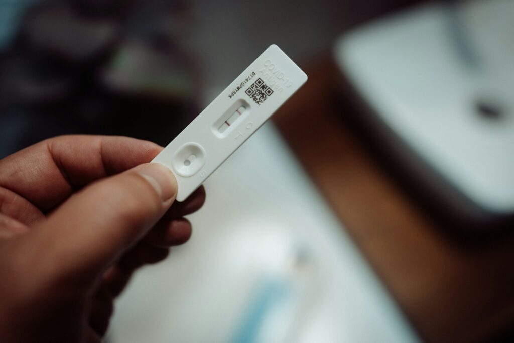 A person holding a pregnancy test.