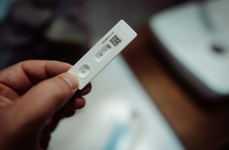 A person holding a pregnancy test.