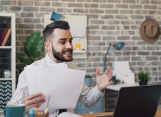 Facial Hair Gains Acceptance at Work as Grooming Expectations Rise A bearded man working on a laptop.