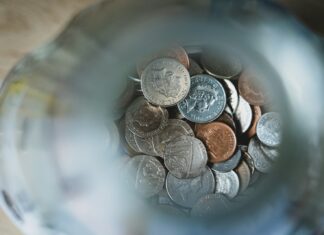 Financial Stress ‘Drains UK Workplace Productivity And Wellbeing’ silver round coins on blue round container