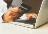 UK Employers Urged To Spot Signs of Gambling Harms as World Cup Fever Hits person using laptop computer holding card