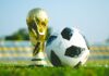 World Cup Absences ‘Could Impact Workplace Productivity as Fans Plan Sick Days’ gold-colored trophy and soccerball