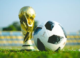 World Cup Absences ‘Could Impact Workplace Productivity as Fans Plan Sick Days’ gold-colored trophy and soccerball