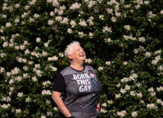 LGBTQ+ Workers ‘Face Distinct Retirement Challenges and Opportunities’ a man standing in front of a bush